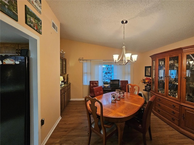 dining area with an inviting chandelier, lofted ceiling, dark hardwood / wood-style floors, and a textured ceiling