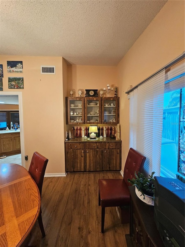 interior space with dark hardwood / wood-style floors and a textured ceiling