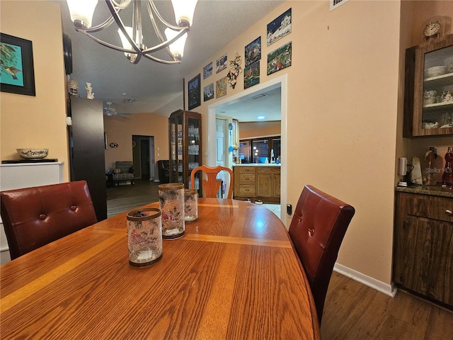 dining area with an inviting chandelier and hardwood / wood-style floors