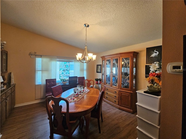 dining area featuring dark wood-type flooring, vaulted ceiling, a textured ceiling, and a notable chandelier