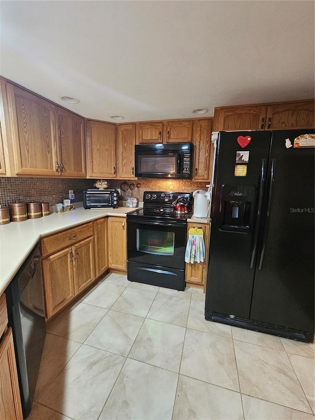 kitchen featuring tasteful backsplash and black appliances