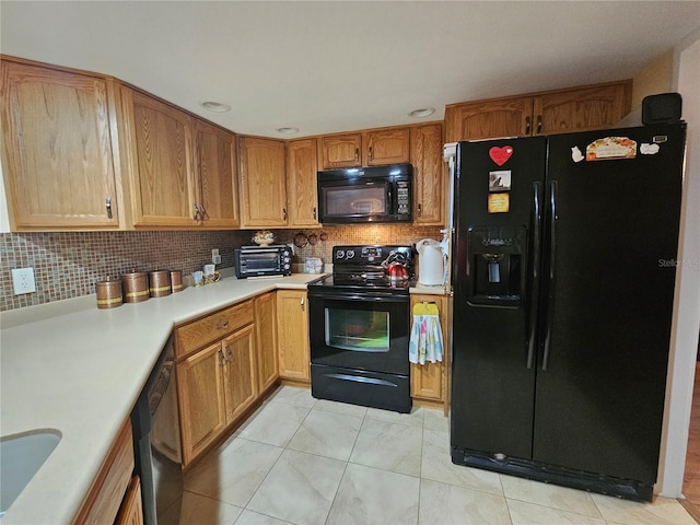 kitchen with backsplash and black appliances