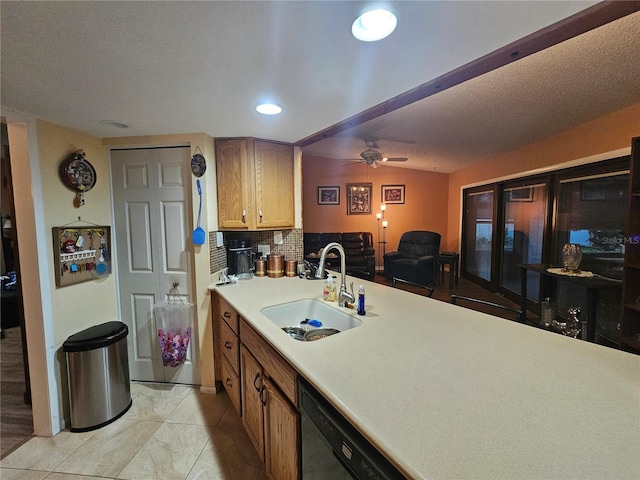 kitchen featuring tasteful backsplash, sink, black dishwasher, and ceiling fan