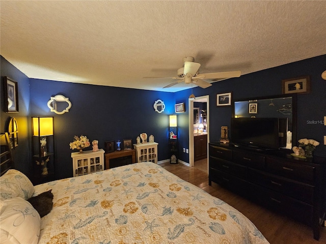 bedroom featuring ceiling fan, dark hardwood / wood-style floors, and a textured ceiling