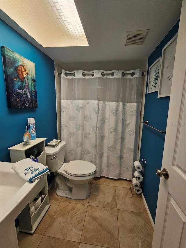 bathroom featuring tile patterned floors and toilet