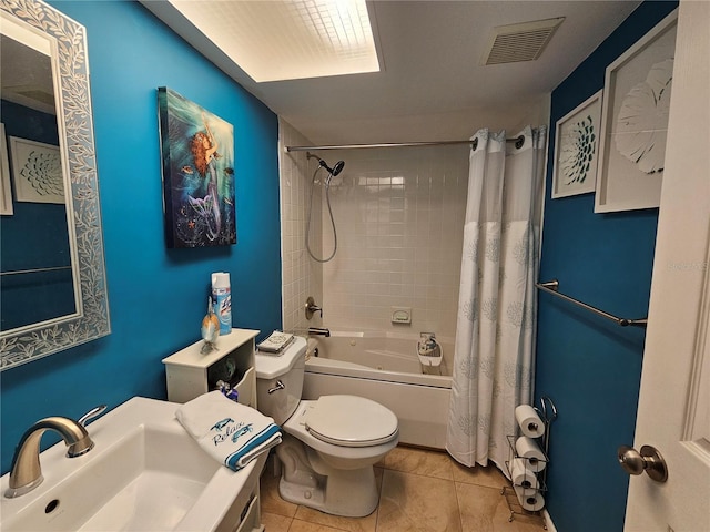 full bathroom featuring sink, shower / bathtub combination with curtain, tile patterned floors, and toilet