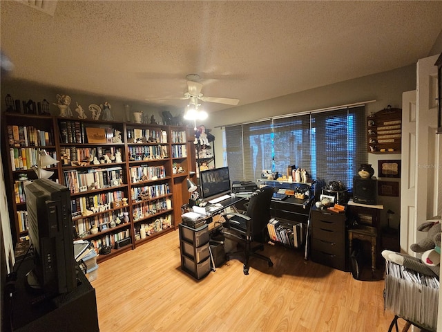 office space with ceiling fan, a textured ceiling, and light wood-type flooring