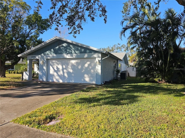 view of home's exterior featuring a garage, central AC, and a lawn