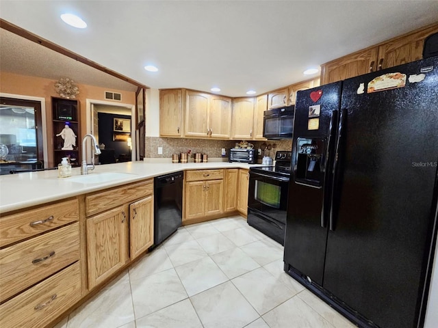 7711 Innis Ct, Saint Petersburg, FL 33709 - kitchen with light countertops, decorative backsplash, a sink, visible vents, and black appliances