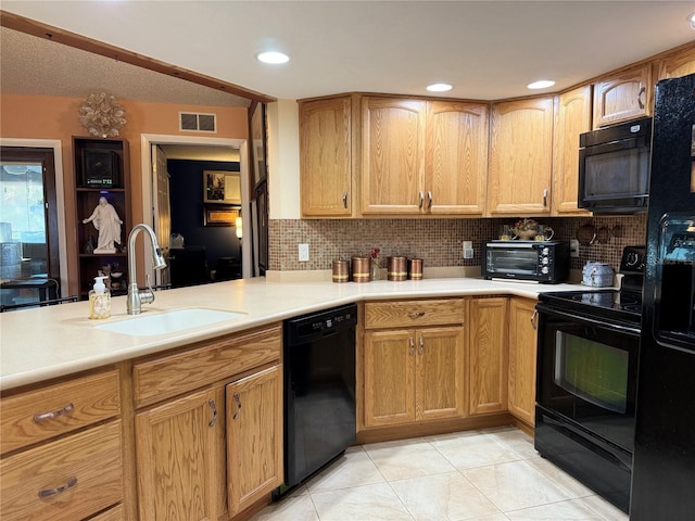 7711 Innis Ct, Saint Petersburg, FL 33709 - kitchen featuring light countertops, a sink, a toaster, visible vents, and black appliances