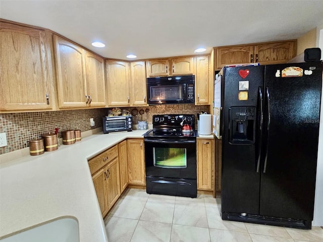 7711 Innis Ct, Saint Petersburg, FL 33709 - kitchen with light countertops, tasteful backsplash, black appliances, and a toaster