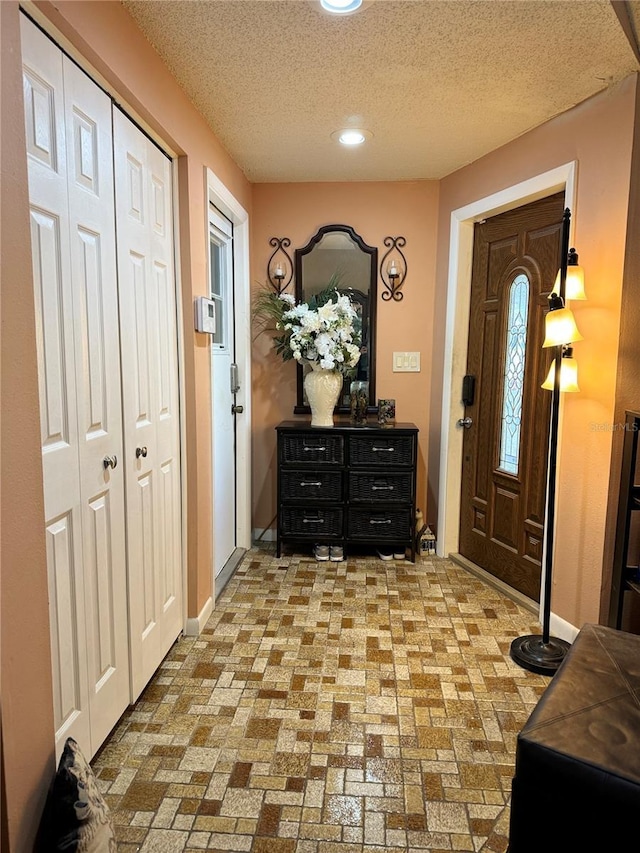 7711 Innis Ct, Saint Petersburg, FL 33709 - entryway with baseboards, a textured ceiling, brick floor, and recessed lighting