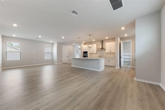 unfurnished living room with light hardwood / wood-style floors