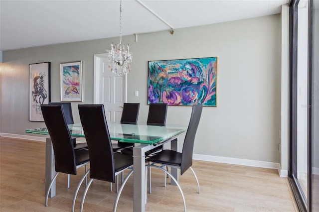 dining room featuring a chandelier and light hardwood / wood-style flooring