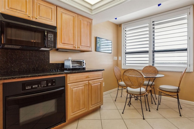 kitchen with crown molding, dark stone counters, light tile patterned floors, and black appliances