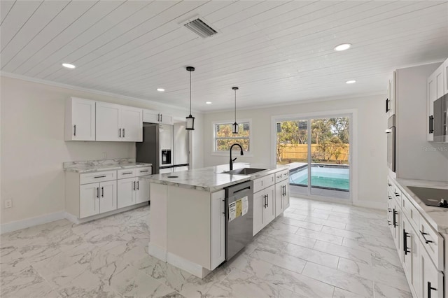 kitchen with white cabinetry, sink, decorative light fixtures, and an island with sink