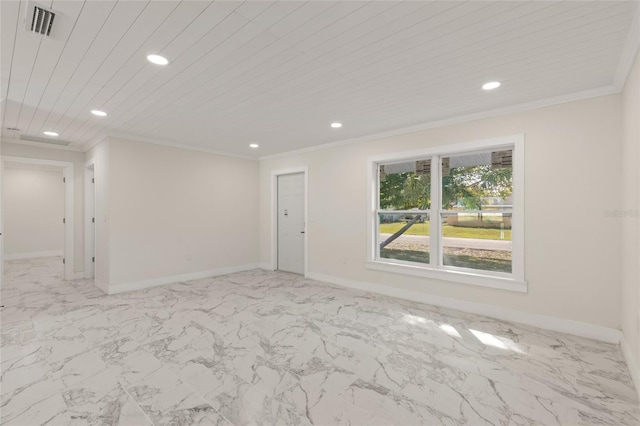 empty room featuring crown molding