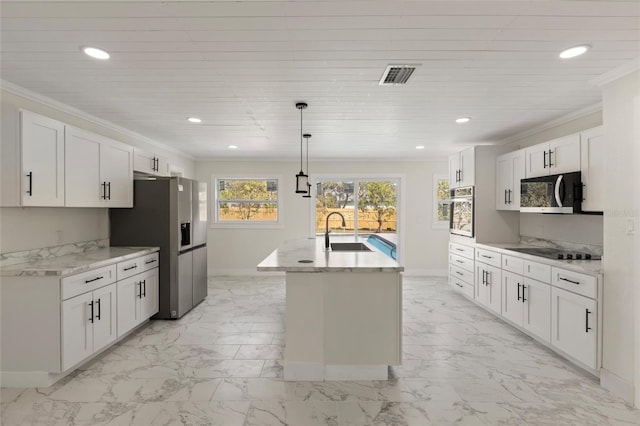 kitchen with decorative light fixtures, white cabinetry, sink, stainless steel appliances, and a center island with sink