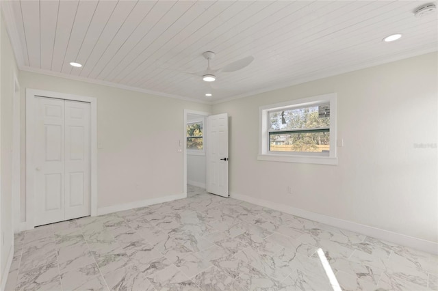 empty room featuring wood ceiling, ornamental molding, and ceiling fan