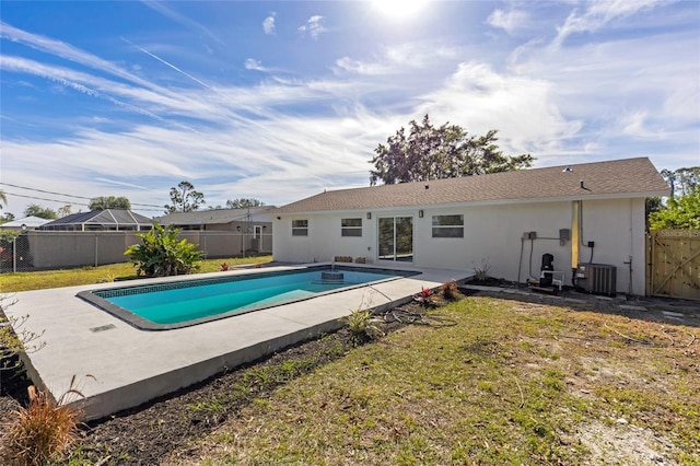 view of pool with central AC unit, a yard, and a patio