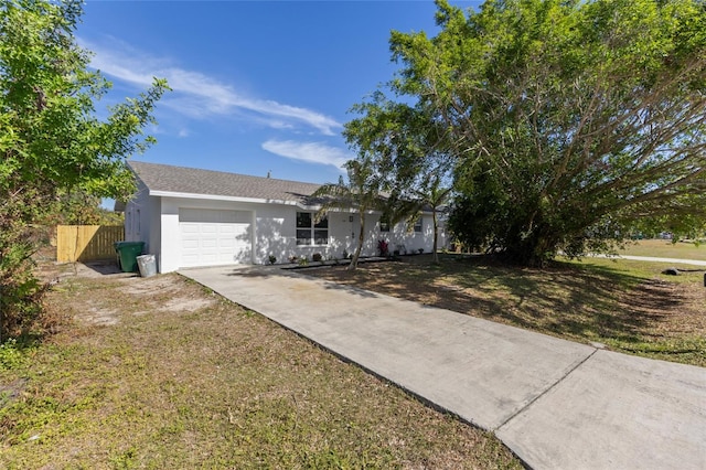 ranch-style house with a garage and a front yard