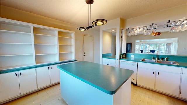 kitchen with a kitchen island, pendant lighting, white cabinetry, sink, and white dishwasher