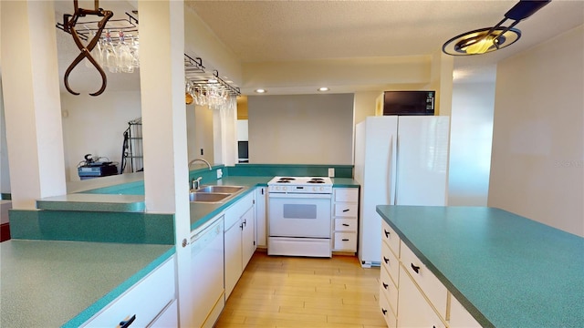 kitchen featuring white cabinetry, sink, white appliances, and light hardwood / wood-style flooring