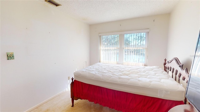 carpeted bedroom with a textured ceiling