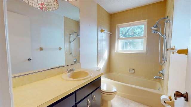 full bathroom featuring tiled shower / bath, vanity, and toilet