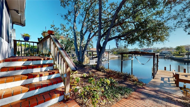 exterior space featuring a water view and a dock