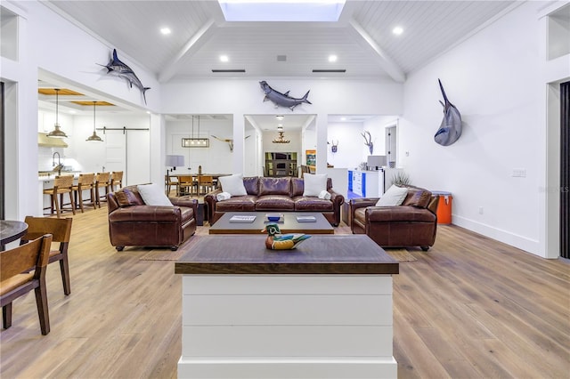 living room with wood ceiling, beam ceiling, sink, and light hardwood / wood-style flooring