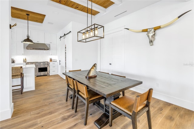 dining room featuring wooden ceiling, a barn door, beam ceiling, and light wood-type flooring