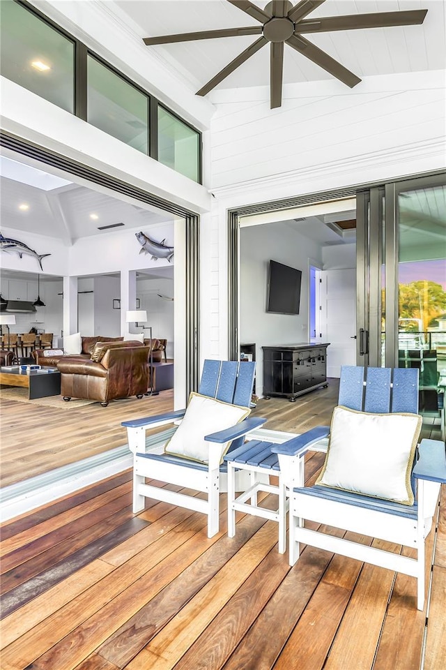 deck featuring ceiling fan and outdoor lounge area