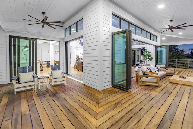 wooden terrace with ceiling fan and outdoor lounge area