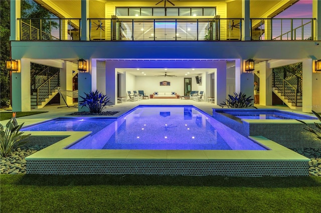 view of pool with an in ground hot tub, an outdoor living space, and a patio area