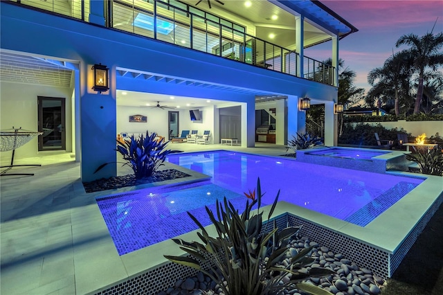 view of swimming pool featuring a patio and an in ground hot tub