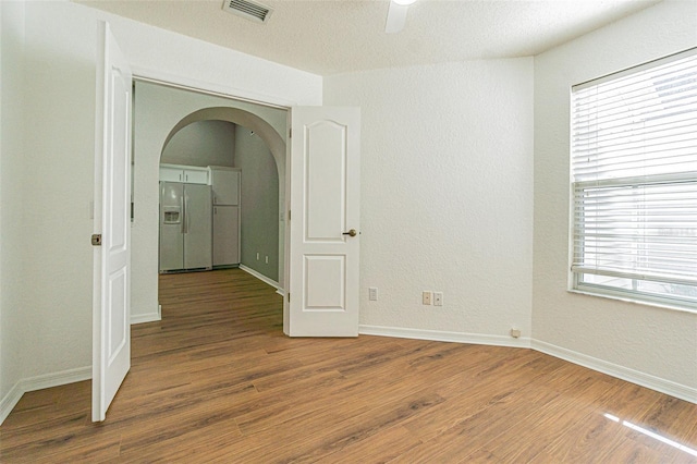 corridor with hardwood / wood-style flooring