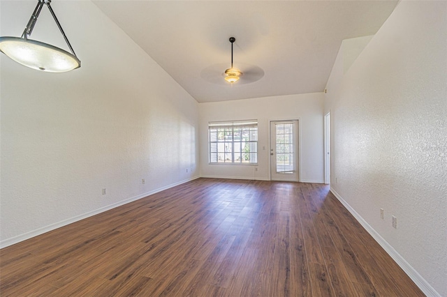 empty room with ceiling fan and dark hardwood / wood-style flooring