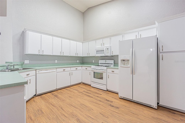 kitchen with sink, a textured ceiling, white appliances, light hardwood / wood-style floors, and white cabinets