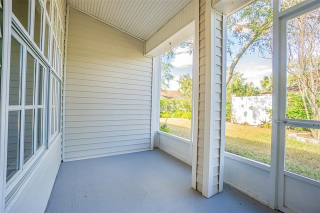 unfurnished sunroom featuring lofted ceiling