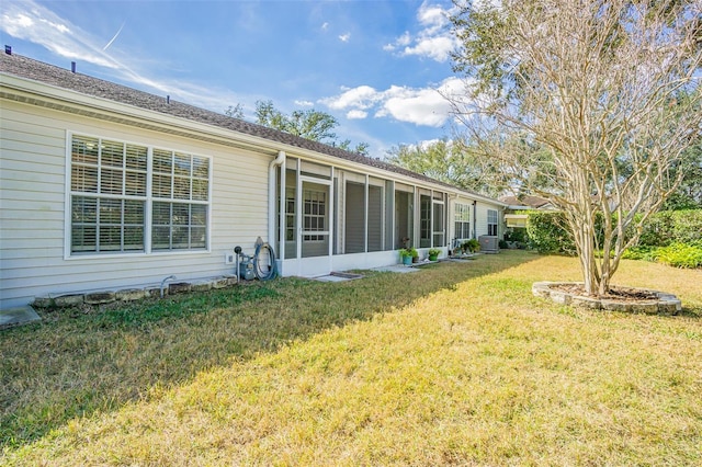 back of property with central AC and a lawn