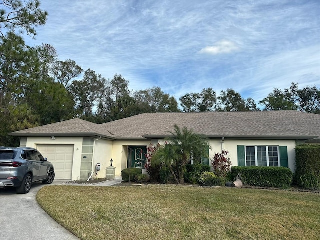 single story home featuring a garage and a front lawn