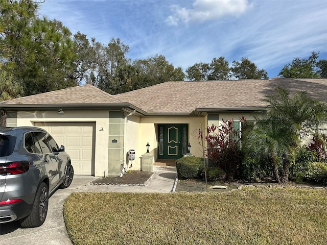 single story home with a garage and a front yard