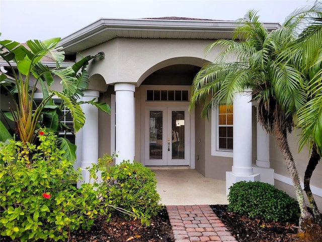 view of exterior entry featuring a patio area and french doors