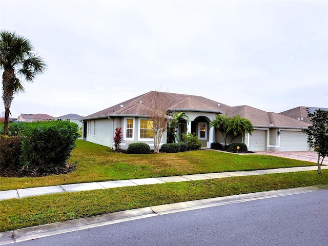 view of front of home with a garage and a front lawn