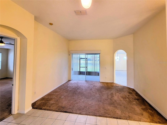 carpeted spare room with ceiling fan