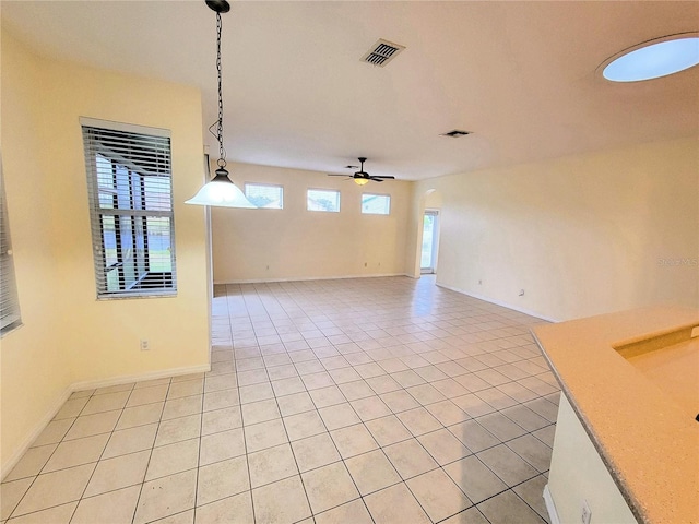 empty room featuring ceiling fan and light tile patterned floors