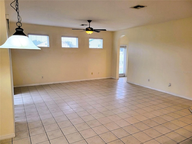 tiled empty room with ceiling fan