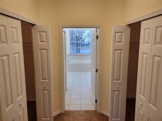 hall with light tile patterned floors