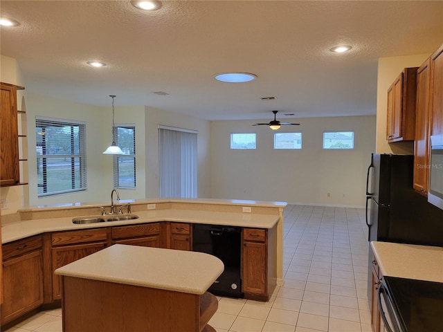 kitchen featuring sink, light tile patterned floors, dishwasher, a kitchen island, and pendant lighting